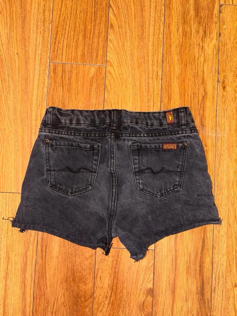Black denim shorts with a distressed look